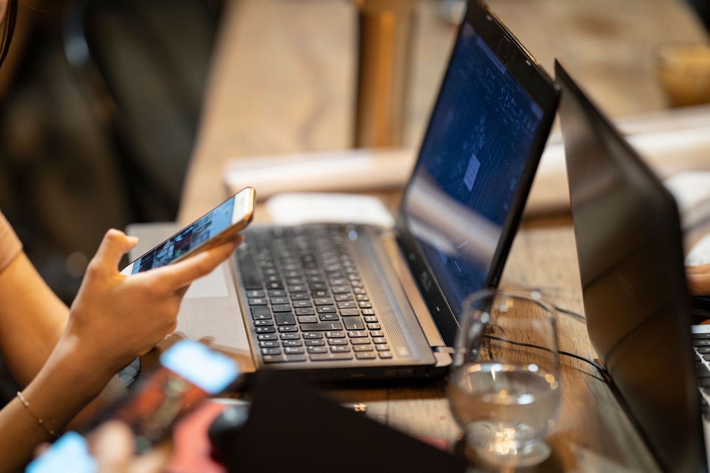 A phone and a laptop on a café table.